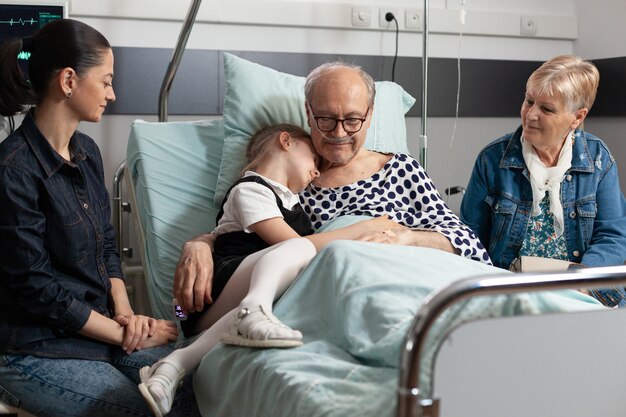caring-grandchild-hugging-sick-elderly-grandparent-showing-love_482257-20397