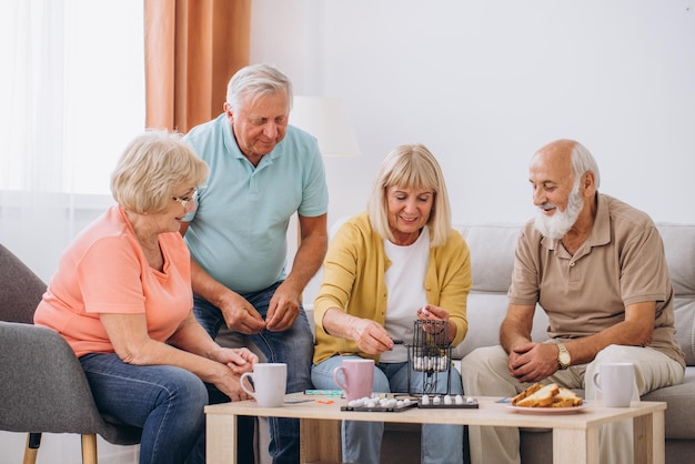 group-four-cheerful-senior-people-playing-bingo-game-nursing-home_1429-12708