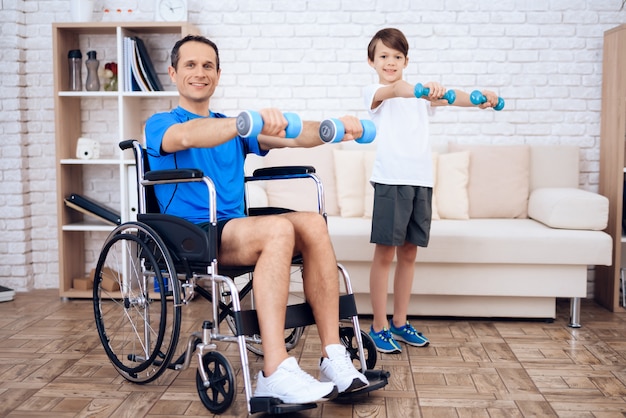 man-wheelchair-son-with-dumbbells-hands_85574-1070